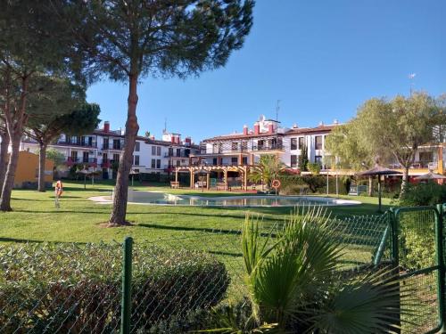 a park with a fence and trees and buildings at APARTAMENTO MANUELA PROXIMO a GOLF ISLA CANELA LINKS in Ayamonte