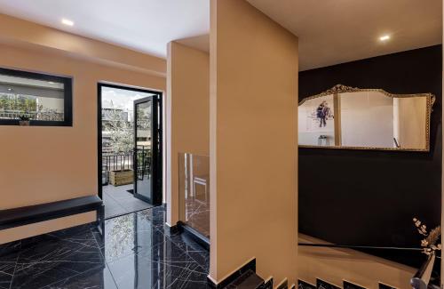 a hallway of a house with a mirror at Clyde Athens by Nin&Bau in Athens