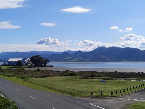 an empty road with a view of a lake and mountains at The Bowentown in Bowentown
