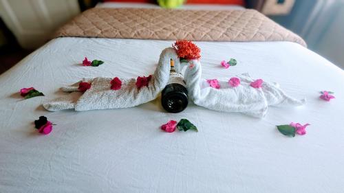a couple of towel animals on a bed with flowers at Sunset Lane in Laborie