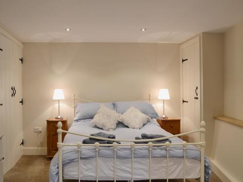 a bed with two pillows on it in a bedroom at The Granary in Tiverton