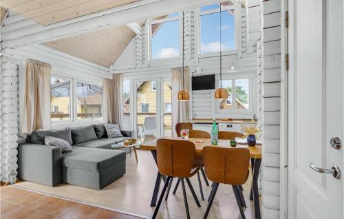 a dining room and living room with a table and chairs at Gorgeous Home In Tranekær in Tranekær