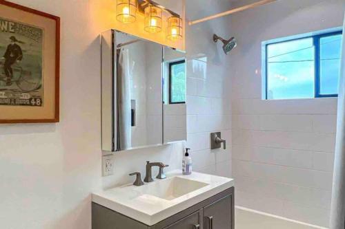 a bathroom with a sink and a mirror at Hillside Silverlake - Echo Park and Free Parking in Los Angeles