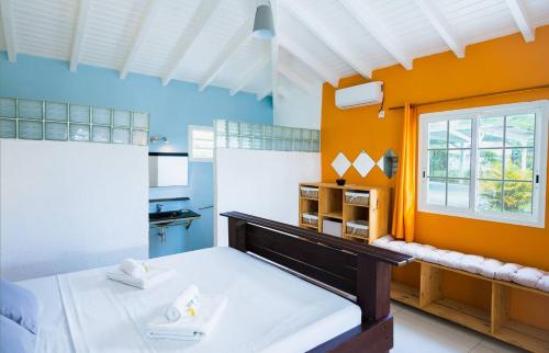 a large room with a bed and a window at La Villa Soleil :) in Sainte-Anne
