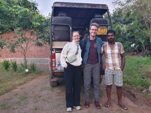 a group of three people standing in front of a truck at Ceylon Resort in Wilpattu