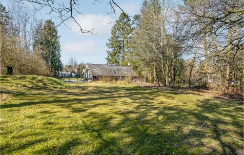 an open field with a barn in the background at Awesome Home In Glesborg With Sauna in Glesborg
