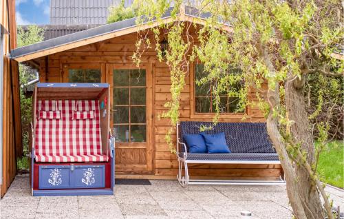 a gazebo with a bench and a chair at Awesome Home In Krusendorf Schwedeneck in Jellenbek