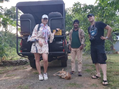 a group of three people standing in front of a truck at Ceylon Resort in Wilpattu