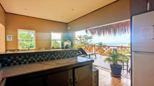a kitchen with a view of the ocean from a balcony at Sunset Lane in Laborie