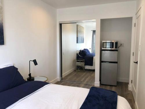 a bedroom with a bed and a microwave in it at Silverlake and Echo Park - 6min to Downtown and Hollywood - in Los Angeles