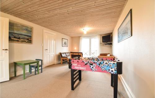 a bedroom with a bed and a table in a room at Holiday Home Kystvej Frørup Xii in Tårup