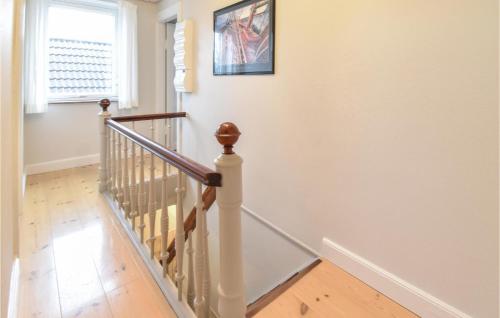 a staircase in a home with white walls and wooden floors at Holiday Home Kystvej Frørup Xii in Tårup