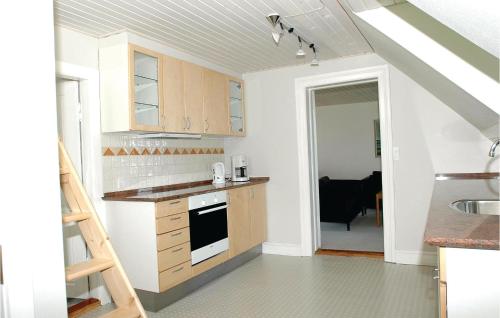 a kitchen with a staircase leading into a room at Holiday Home Kystvej Frørup Xii in Tårup