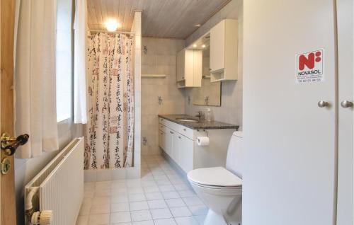 a small bathroom with a toilet and a sink at Stunning Home In Frrup With House Sea View in Tårup
