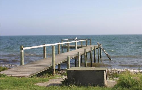 a wooden pier on the shore of the ocean at Holiday Home Kystvej Frørup Xii in Tårup