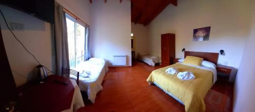 a bedroom with a bed and a large window at Posada Inguz in Villa Berna
