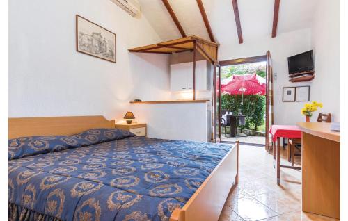 a bedroom with a bed and a table and a table at Gorgeous Apartment In Porec-mugeba With Wifi in Mugeba