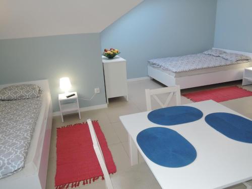 a blue and white bedroom with two beds and a rug at Holiday home in Wiselka in Wisełka