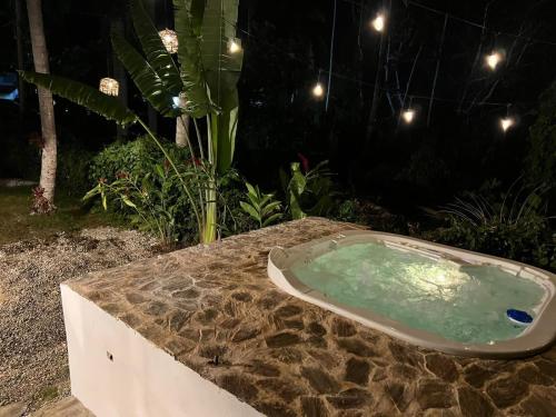 a bath tub sitting on top of a stone table at Playa Bonita 4 minute walk from our private Villa Anantara Bonita in Las Terrenas