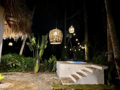 a night view of a garden with a chandelier at Playa Bonita 4 minute walk from our private Villa Anantara Bonita in Las Terrenas