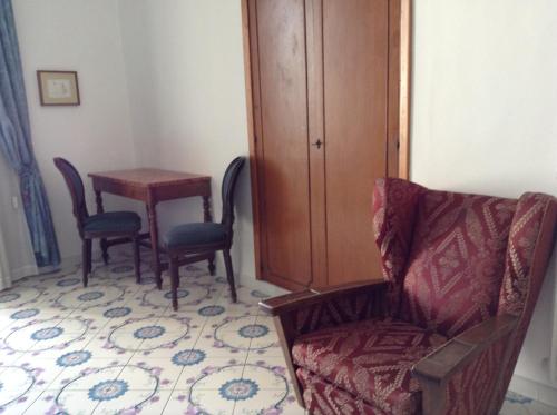 a living room with a chair and a table at Hotel Lidomare in Amalfi
