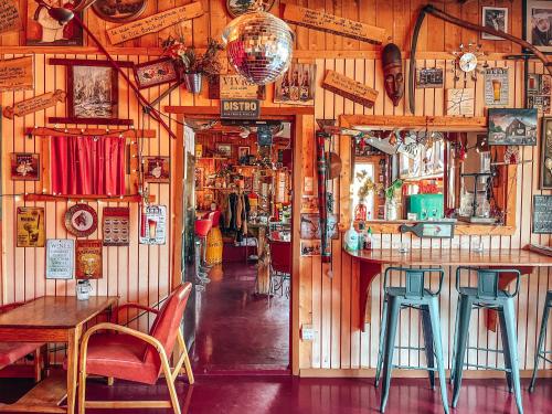 a pub with a bar with chairs and a table at Auberge Mandala in Saint Mathieu Du Parc