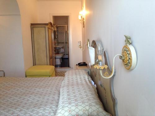 a bedroom with a bed and a mirror on the wall at Hotel Lidomare in Amalfi