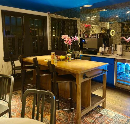 a kitchen with a wooden table and chairs at The Poppy Georgetown Guesthouse and Gardens in Washington, D.C.