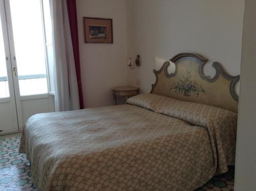 a bedroom with a bed in a room with a window at Hotel Lidomare in Amalfi