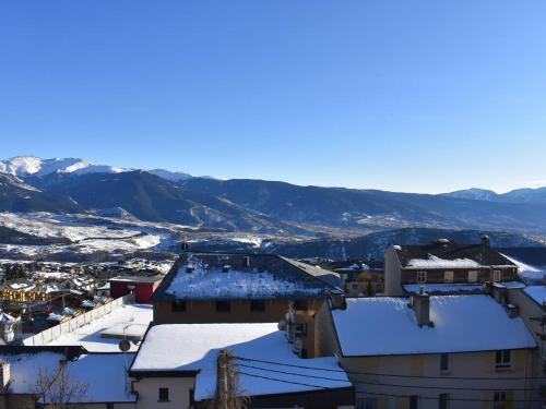 eine schneebedeckte Stadt mit Bergen im Hintergrund in der Unterkunft Studio Cabine au Centre, Accès Direct aux Pistes, WIFI, Parking - FR-1-580-86 in Font Romeu Odeillo Via