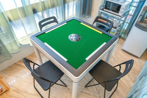a table with chairs around it with a globe on it at 慕研民宿 包棟 KTV 游泳池 羅東運動公園 22p in Yilan City