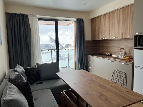 a kitchen with a couch and a table in a room at Delux apartment for 6 guest, new gudauri in Gudauri