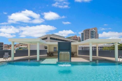 a pool with a gazebo on top of a building at Townsville City Ocean View Apartment in Townsville