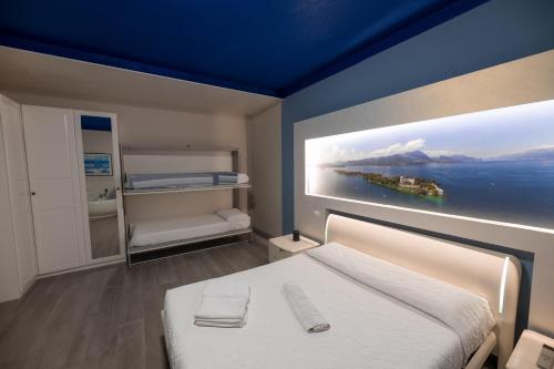 a bedroom with a bed with a painting on the wall at Garda Fantasy Apartment - JACUZZI in Desenzano del Garda