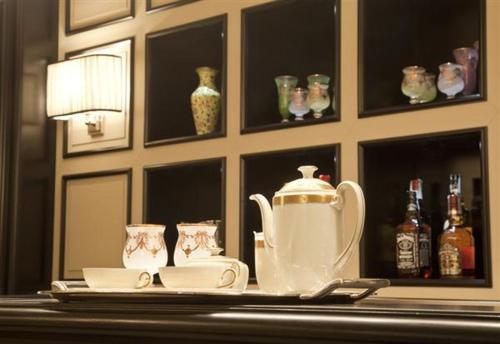 a table with a tea pot and cups on it at Hotel Patria in Pistoia