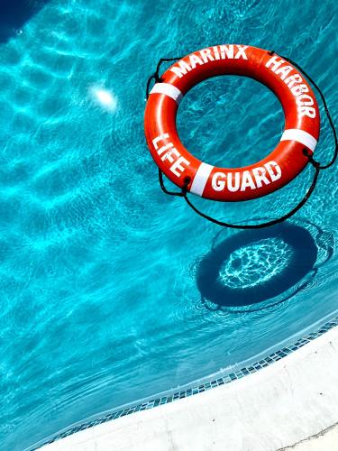 a red life guard raft in a swimming pool at MARINX CLASSIC HARBORVIEW PENSION in Yaese