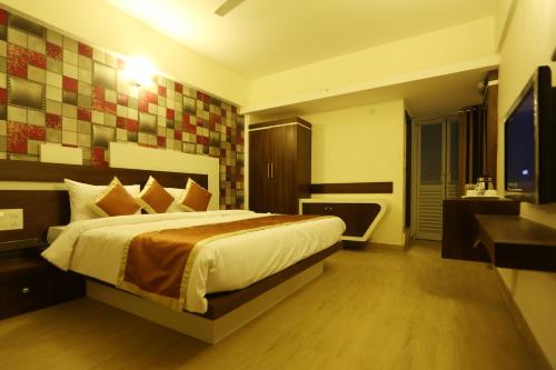 a bedroom with a large bed and a bathroom at moriz inn in Mysore