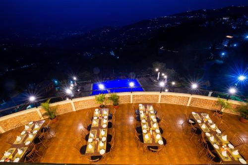 a group of tables with lights at night at Himalaya Drishya Resort in Dhulikhel