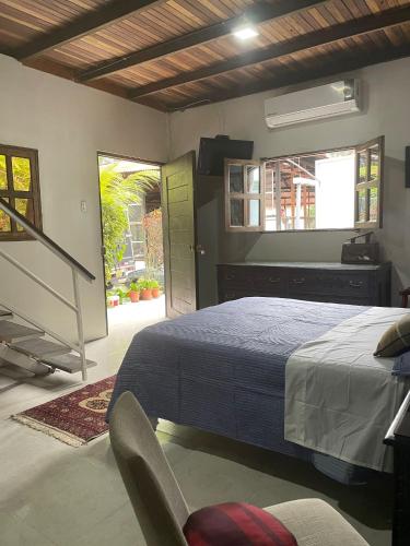 a bedroom with a bed and a chair in it at Amazon Lodge Varillal in Iquitos