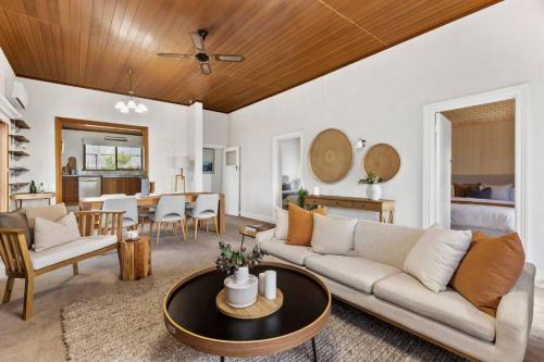 a living room with a couch and a table at Swan View in Queenscliff