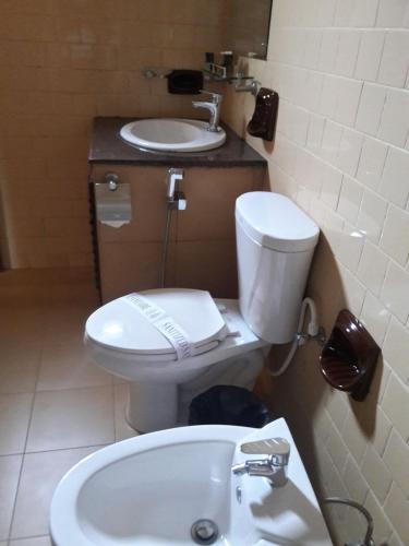 a bathroom with a toilet and a sink at New Kandy Residence in Kandy