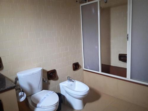 a bathroom with a toilet and a sink at New Kandy Residence in Kandy