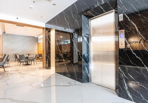 a lobby with a revolving door in a restaurant at KIYANA HOTEL SEMARANG in Jomblang