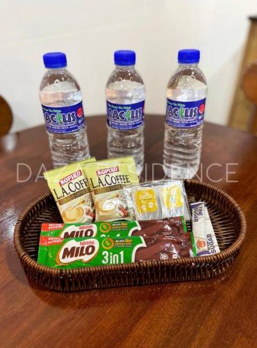 a basket of food and water bottles on a table at DAZA RESIDENCE @ TIMURBAY SEAFRONT KUANTAN in Kuantan
