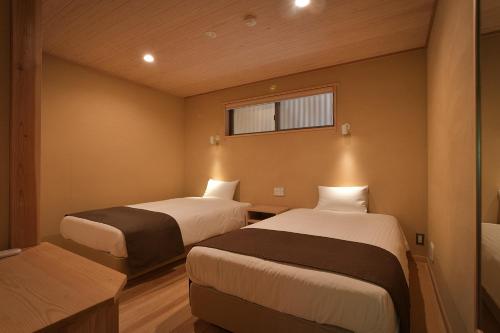 Ein Bett oder Betten in einem Zimmer der Unterkunft Syoubun