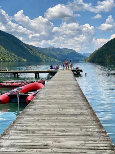 a group of people standing on a dock on a lake at Eco-Chalet Matschiedl in Tratten