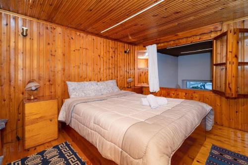 a bedroom with a bed in a wooden room at Dimizis in Methoni
