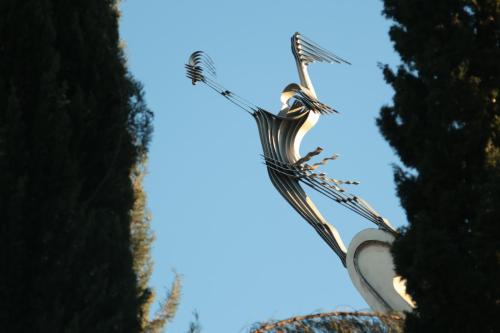 a large kite flying in the sky between two trees at Kai Hotel Bar in Tbilisi City
