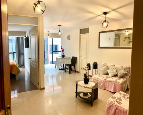 a living room with a couch and a table at Cusco Magico 2 - Aparthotel Condominio Las Torres Kayser II in Cusco