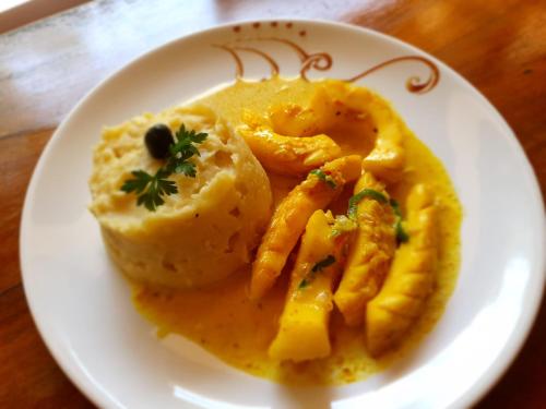 a plate of food with potatoes and fries on a table at Hotel Lakana Ramena in Diego Suarez